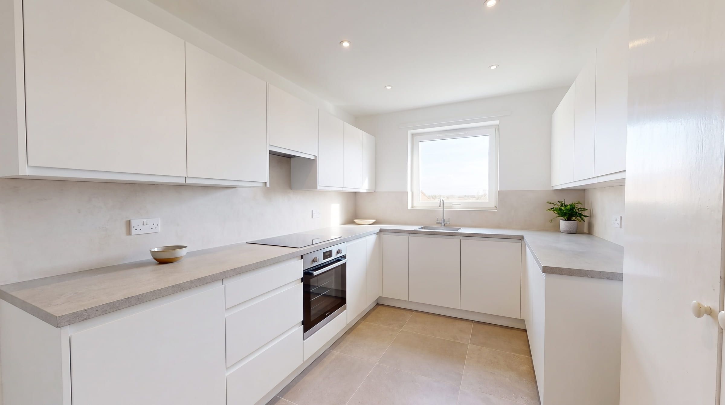 The same kitchen redesigned in a Modern style, with its windows, walls and camera angle unchanged